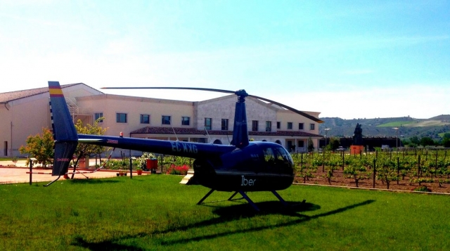 helicopter next to a vineyard 